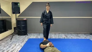 Karate girl kicks footdominates and makes a lot of victory poses on gym security guy part2