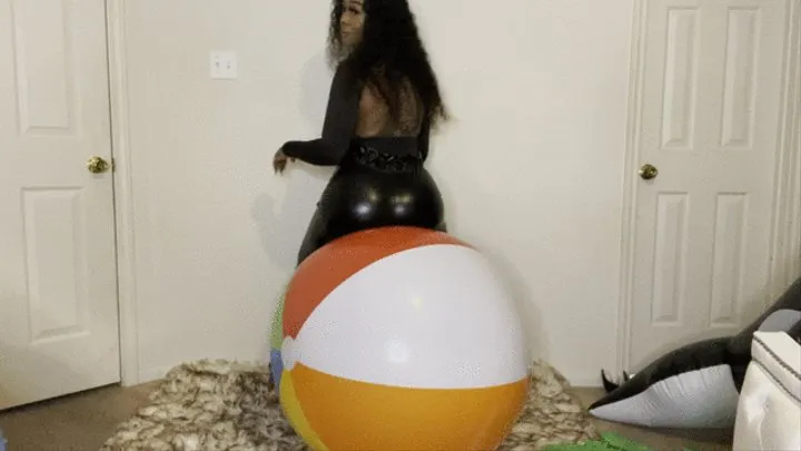 Ass bouncing on large beach ball before finger nail pop