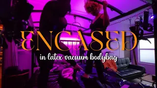 slave dominated in latex vacuum bodybag by two Goddesses