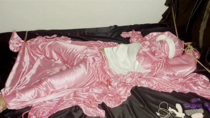 Girl tied on bed in shiny soft pink silk (Part 2)