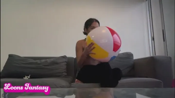 Akina blows up small beach ball and deflates background balls( )