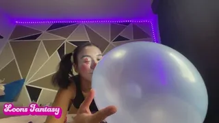 Akina blows up balloon in clown makeup