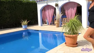 Next to the pool with a black shorts