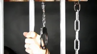 Arianna handcuffed to the bars 1