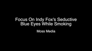 Focus on Indy Fox seductive eyes while smoking on a patio