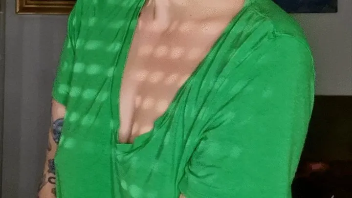 Smoking in a green shirt without bra