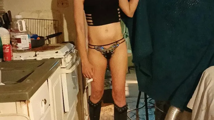 Rocking those sexy boots while smoking two cigarettes