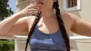 Smoking on the balcony, jean shorts and a sports bra, hair in braids - Smokingrapunzel