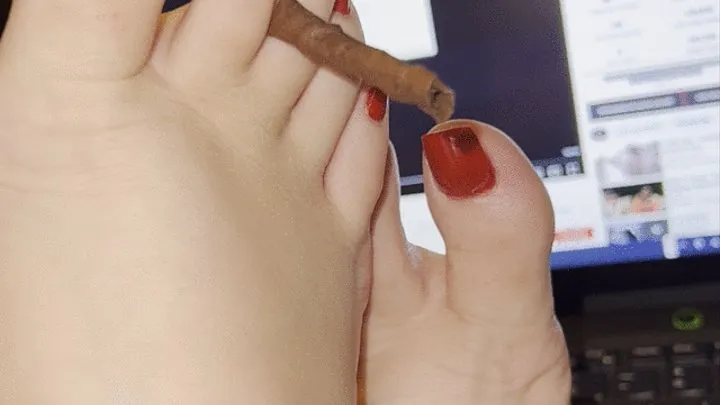 Holding a blunt with my sexy red toes!