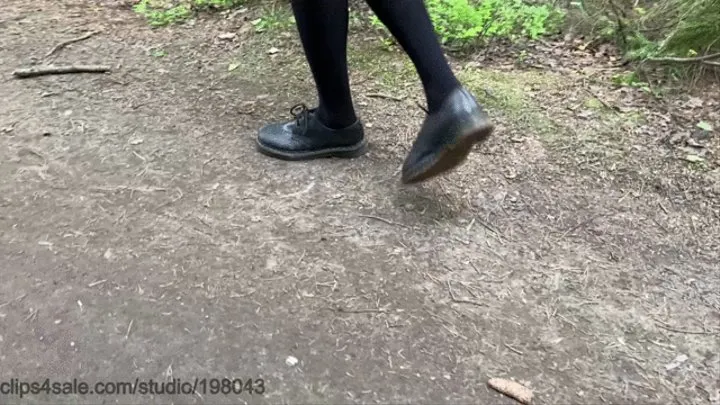 Smocking and dirty shoes posing in the forest