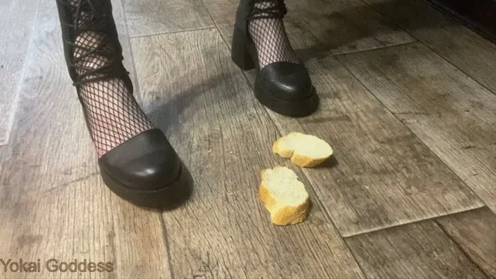 Crushing stale bread with My heeled sandals, spitting on it and making My slave eat it from the floor