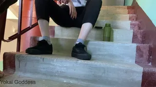 Dirty Vans shoe soles licking in tha public stairs