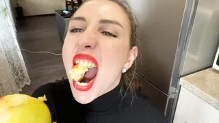 Sharp teeth ripping into the apple
