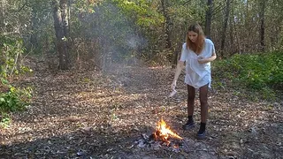 Crazy woman in the woods rips off her clothes and burns them