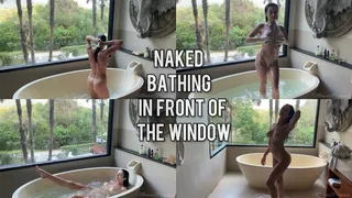 Naked bathing in front of the big window