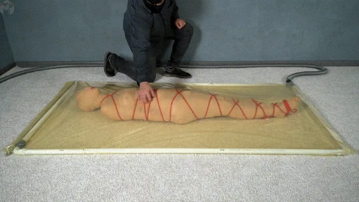 Mummification with bandages and rope bondage with ankle brace in a vacuum bed