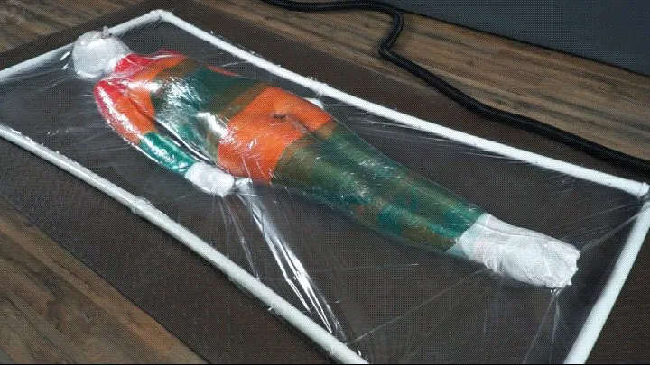Mummification with multicolored stretch wrap in a transparent vacuum bed with vibro and orgasms