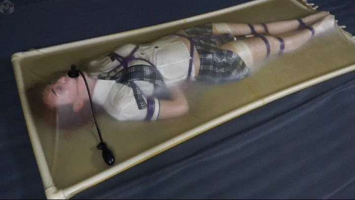 Bondage schoolgirl in latex vacuum bed with vibrator and pear gag