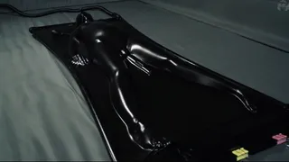 Orgasms in a black latex bed with a pear gag