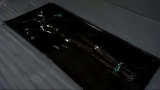 Green glowing bondage in black vacuum bed