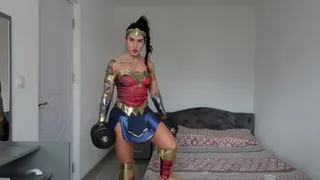 Gemmafitbunny dressed up as a Wonderwoman doing a workout and flexing