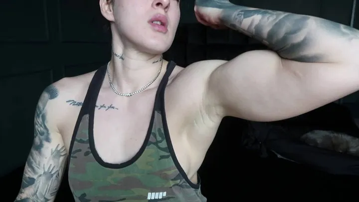 A strong mistress flexing her biceps