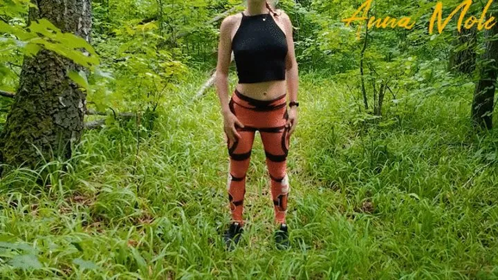 On a walk in the park, a girl in leggings masturbates her pussy