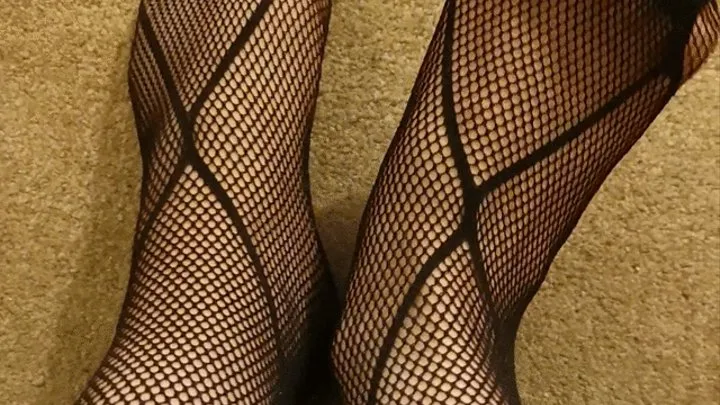 Feet in fishnet stockings