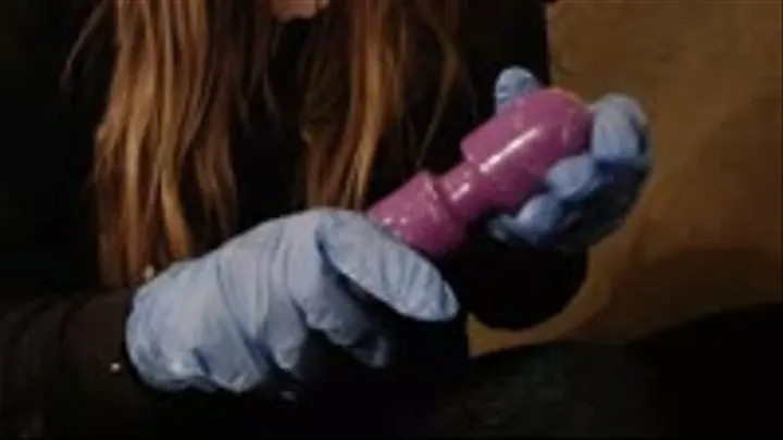 Soaping up a magic wand dildo with latex gloves