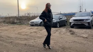 A girl in high-heeled shoes walks off-road, stumbles several times and falls, first injuring her ankle, then dislocating her knee