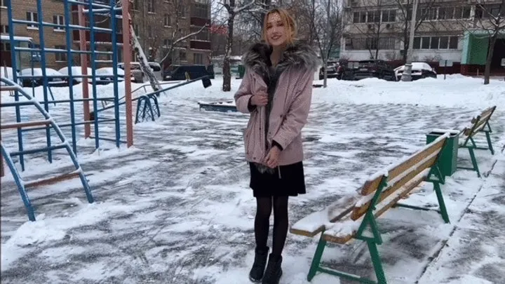 a girl plays on a summer playground in winter at -15 barefoot in stockings and a dress (reupload)