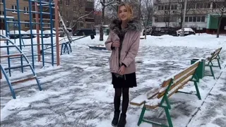 a girl plays on a summer playground in winter at -15 barefoot in stockings and a dress (reupload)