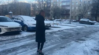 The girl went out for a walk in high heels, but she did not expect that it would be so slippery and there would be ice everywhere