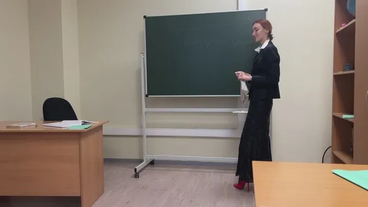 The teacher in the classroom teaches a lesson and plays a little with her sexy high-heeled shoes, but the student does not listen to her, he only dreams of her feet and heels