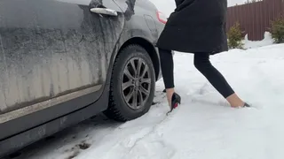 A girl in sexy shoes likes to play with the pedals on someone else's car, she wants to hear a new sound and therefore took someone else's car to press the pedals with her heels and enjoy