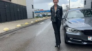 A girl in high-heeled boots walks through deep puddles and checks them for strength, the boots are not very durable and her feet ended up in the water