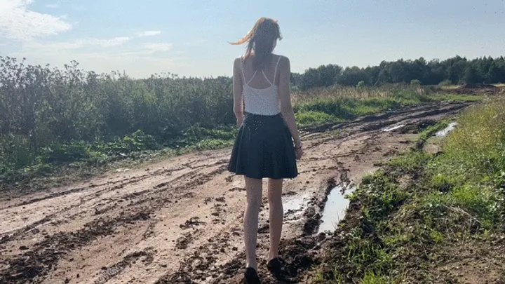 A girl in high-heeled shoes wanted to smear her shoes with mud, but did not expect that it would be so deep that her feet would be sucked inside