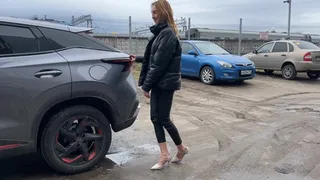 girl in a car plays with her shoes and presses the brake and gas pedals enjoying the sounds of the car