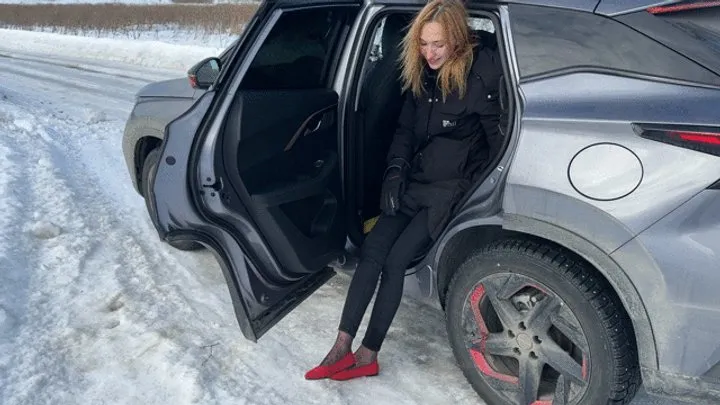 girl in ballet shoes slides on an icy road and loses her ballet shoesE