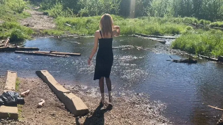 girl splashes her shoes in the water and then walks in sticky mud in wet shoes