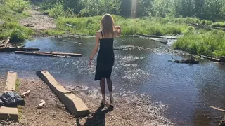 girl splashes her shoes in the water and then walks in sticky mud in wet shoes