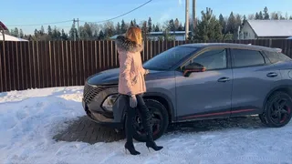 girl in high-heeled boots plays with car pedals