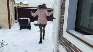 girl in high-heeled boots gets stuck in the snow and falls many times