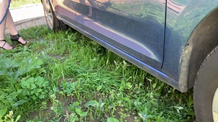 girl in high heels washes a car, her shoes and feet get wet