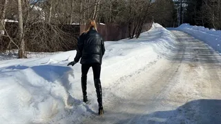 girl walks through the snowdrifts in high-heeled boots and falls deep into the snow