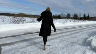 a girl in transparent boots walks on the ice and slips and falls hard