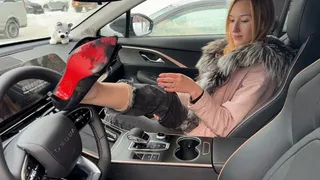girl plays with high heels in the car and presses or pedals