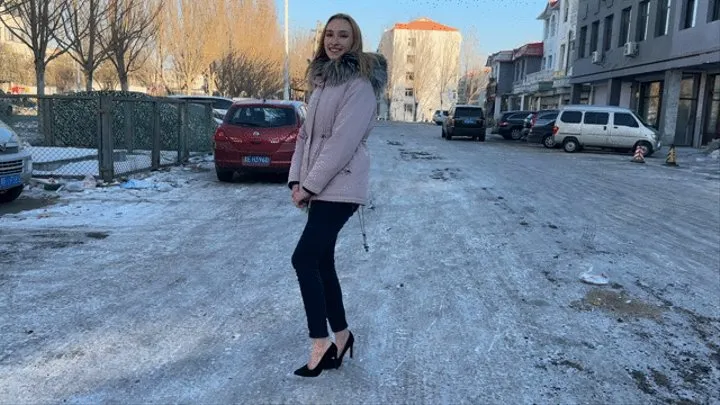 girl decided to walk to the store in high-heeled shoes, but the whole road was covered in ice, her heels were slipping a lot