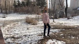 girl in high heels tries to climb an ice slide, but she fails