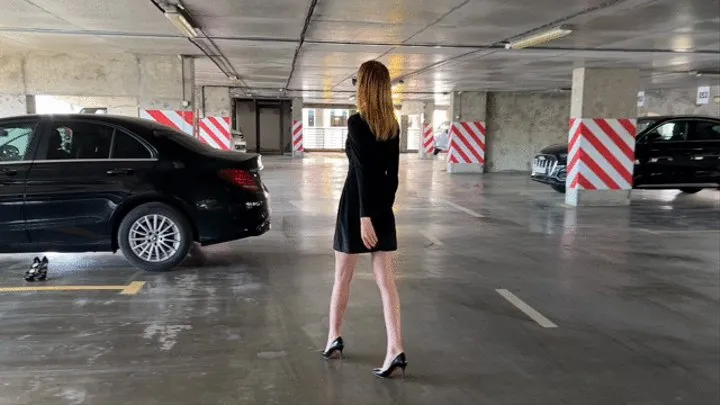 a girl in high-heeled shoes presses the pedals of the car, she changes her shoes and continues to play with the pedals